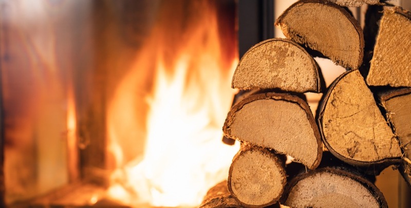 Firewood stack in front of open fireplace